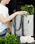 woman unpacking stone colour reusable grocery bag