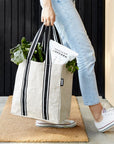 Woman with filled reusable grocery bag