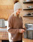 Woman in kitchen opening khaki cooler bag