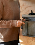 Close up of woman opening khaki cooler bag