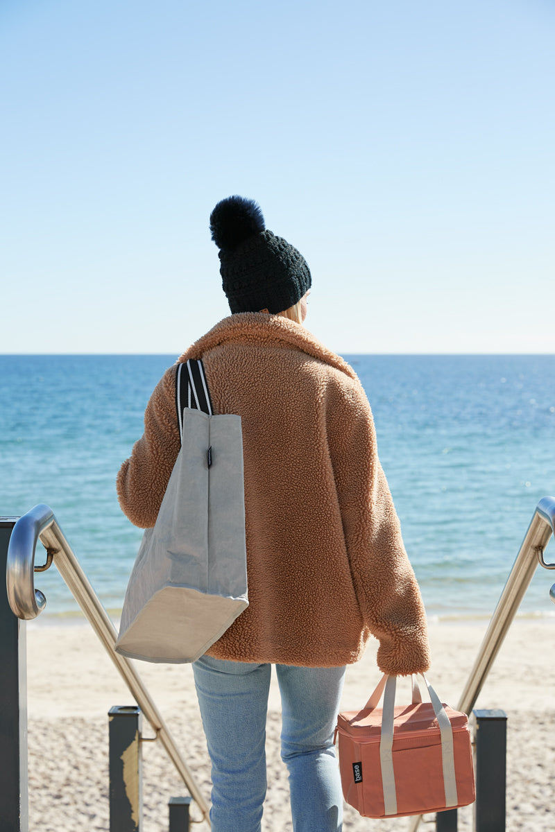 Woman carrying Cooler bags at the beach