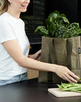Woman unpacking groceries from Khaki recyclable grocery bag