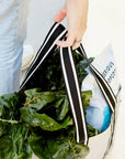Close up of woman holding reusable grocery bag