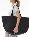 Women carrying large neoprene bag on left shoulder