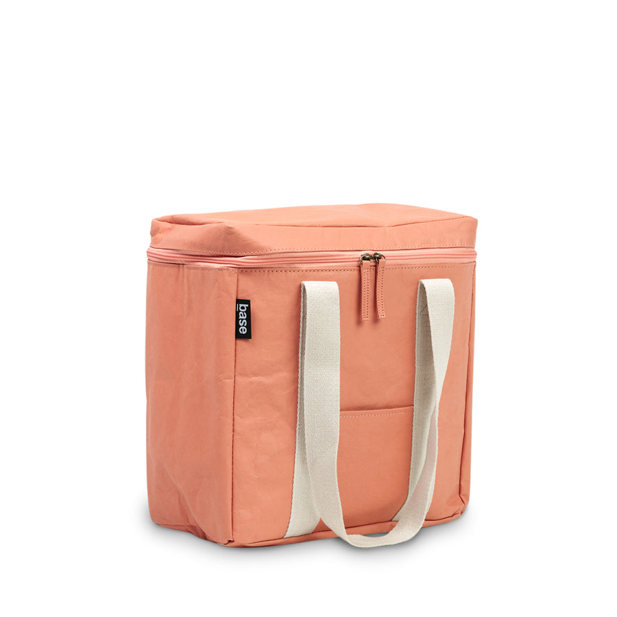 Peach coloured cooler bag with white straps